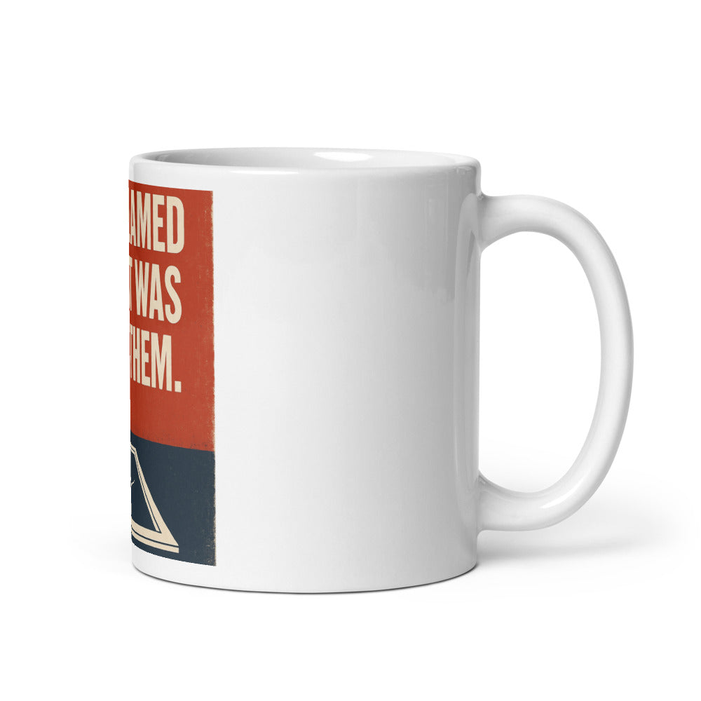 "They Blamed Us. It Was Them." Mug — political satire mug mockup — view 1